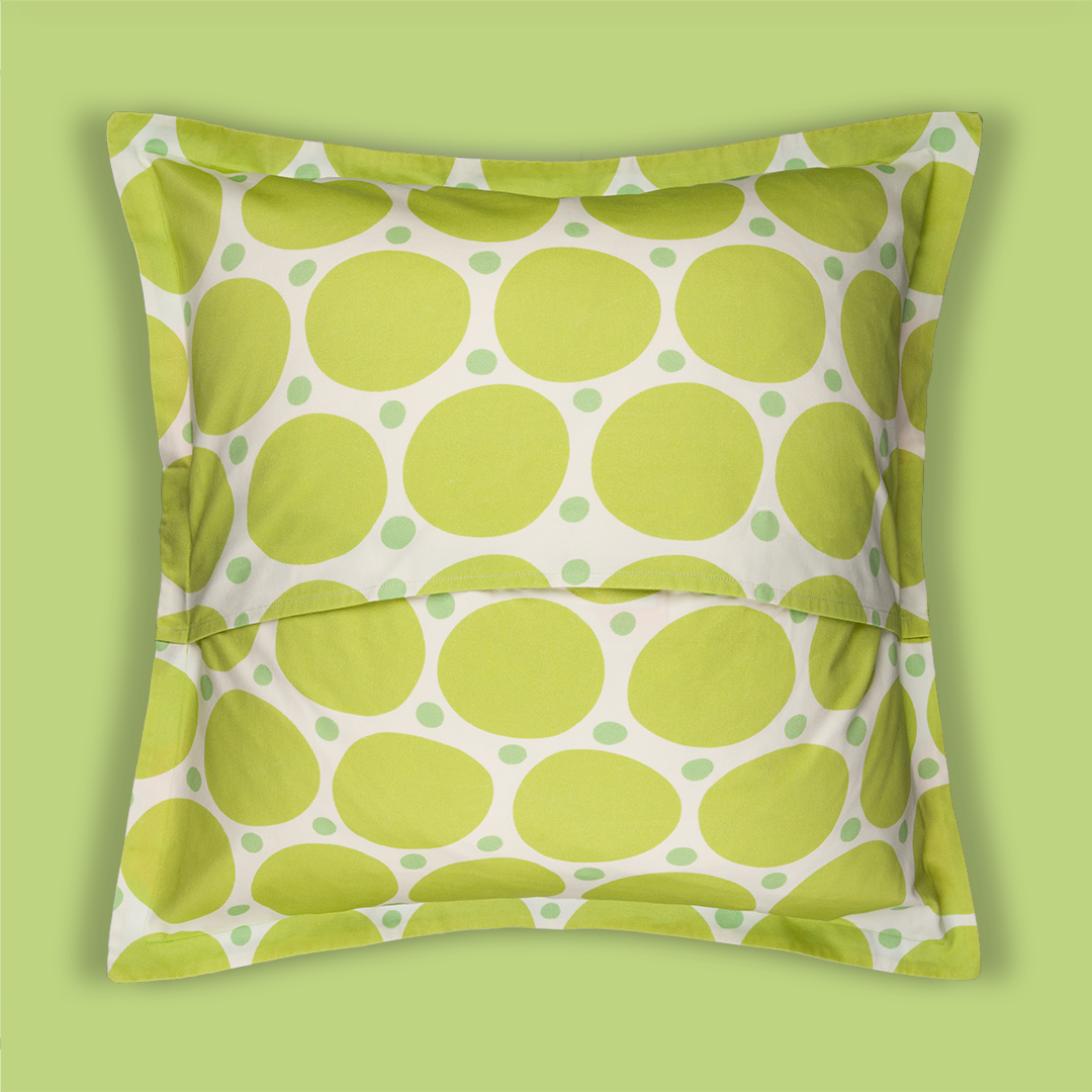 Photo of the back of the pillowcase with light green big dots mixed in with smaller mint colored dots. The background of the pillow is white.