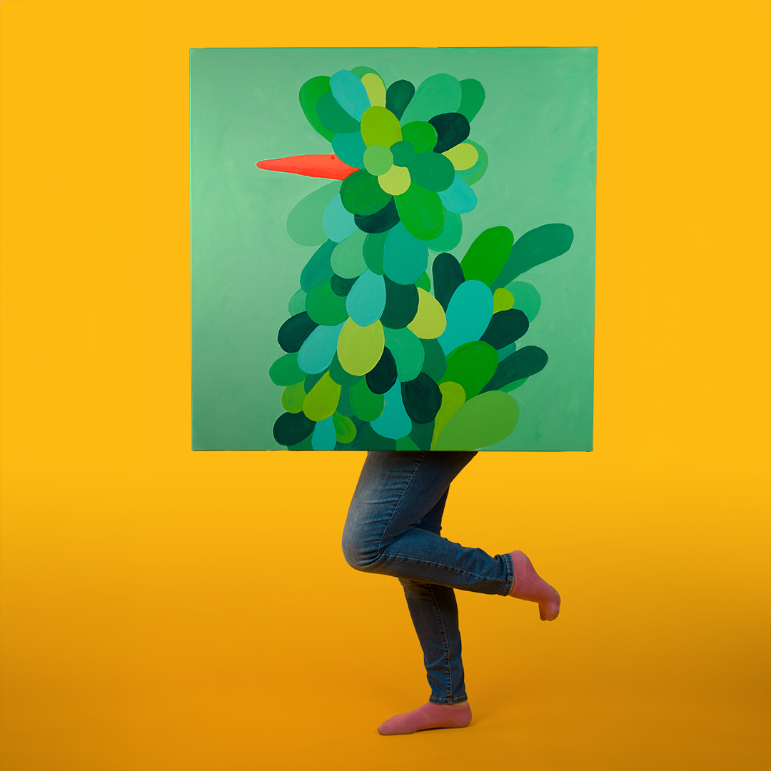Photo of a green chicken painting with a person standing behind the painting with feet posed like a chicken or a flamingo.