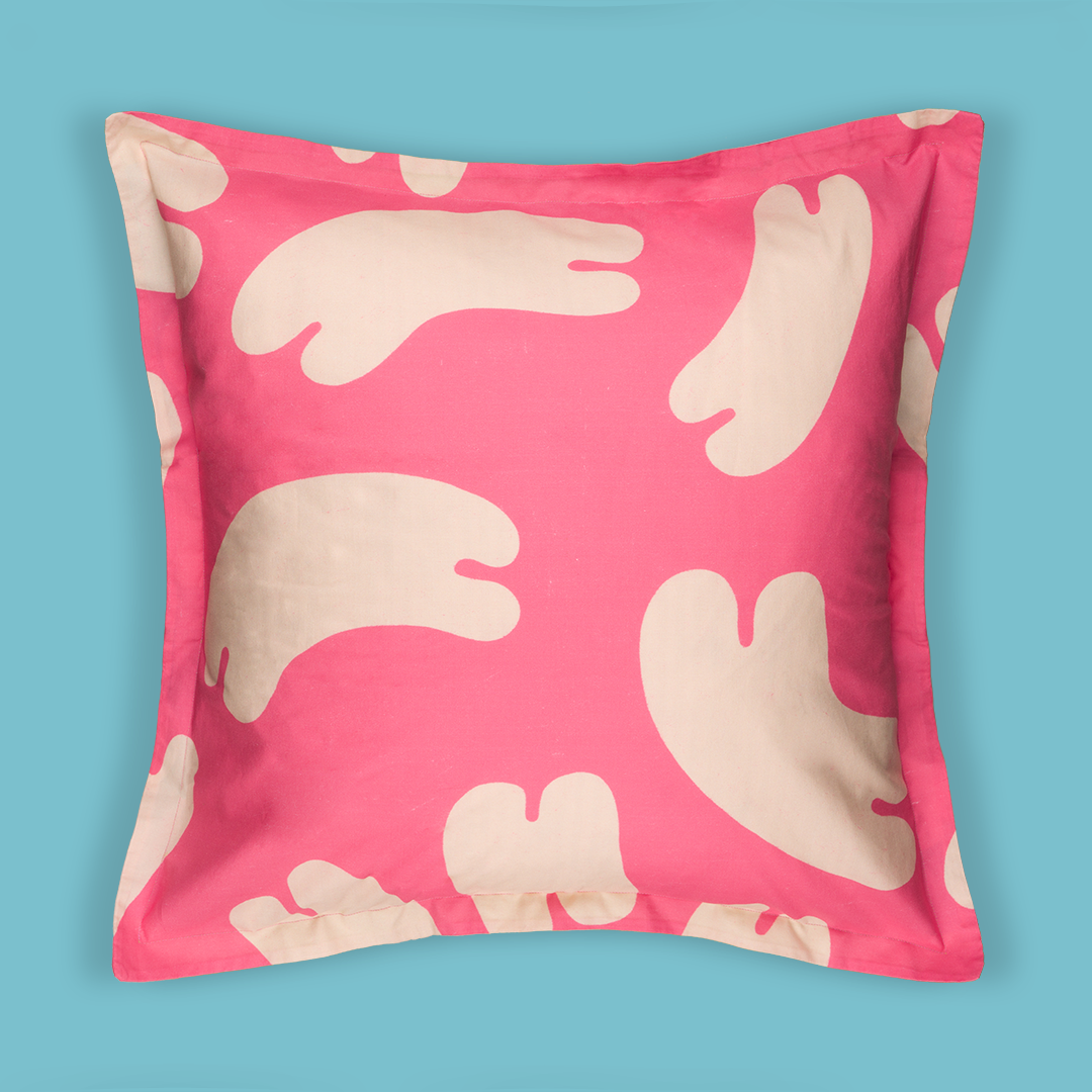 Front of the pillow case print. The print is bright pink with white noodle-like shapes floating all over the pillow.