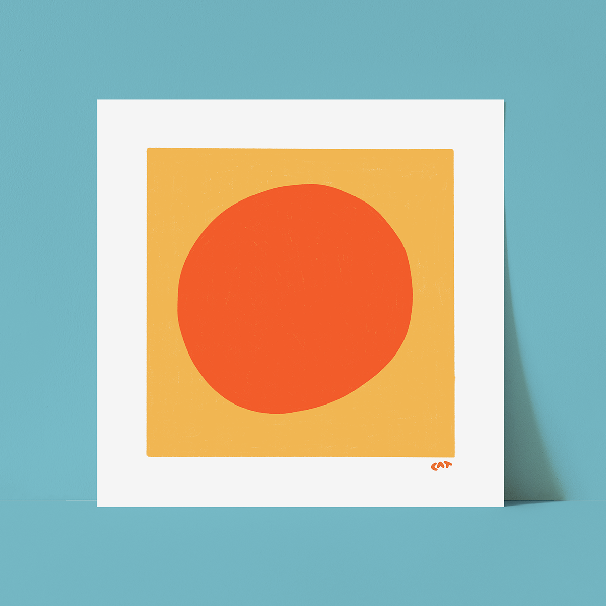 White unframed print of a yellow square with an orange dot in the middle of the square.