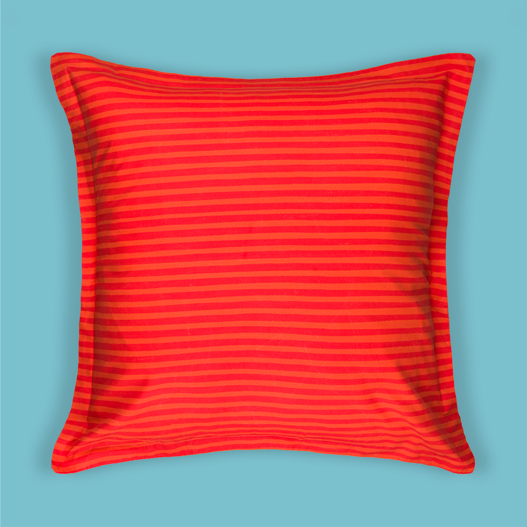 Photo of the front of the pillow with red and orange thin stripes.
